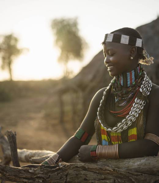 A tranquil moment as a young girl smiles with the golden hour sun setting behind her.
